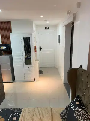 a living room with a white door and a couch at La Nikolina, Cozy Studio near MOA, CCP & Star City, Pasay in Manila