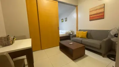 a small living room with a couch and a bed at Full-Serviced Residential Apartment in One Uptown Residences, BGC in Manila