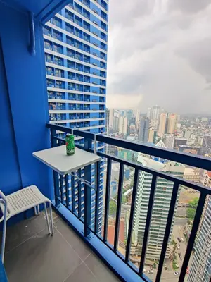 a balcony with a table and a view of a city at Stunning 2BR Condo in AIR Residences Makati High Floor and WFH with 300Mbps Wifi in Manila