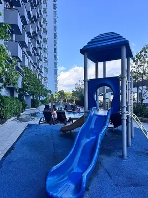 a playground with a blue slide and a gazebo at 2 Bedroom with Balcony in Manila