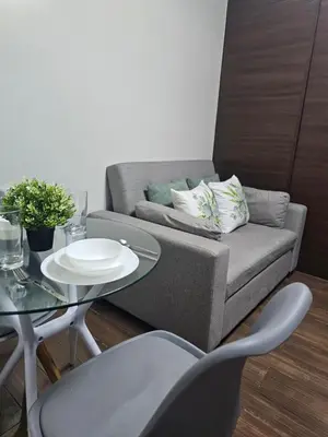 a living room with a couch and a table at Air Residences Makati Sage Haven in Manila