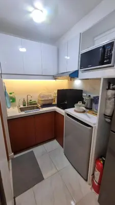 a small kitchen with a sink and a refrigerator at The Villa Staycation at La Verti Residences in Manila