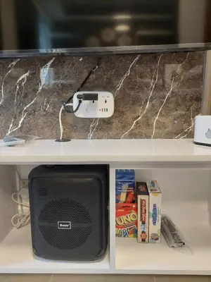 a tv on a shelf with a video game controller at The Villa Staycation at La Verti Residences in Manila
