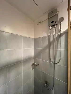 a shower stall in a bathroom with a shower at Sea Residences MOA Pasay City- Kirk in Manila