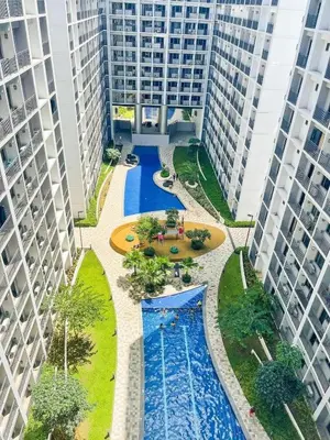 an overhead view of a pool between two tall buildings at Budget Condo near Airport and Mall of Asia in Manila