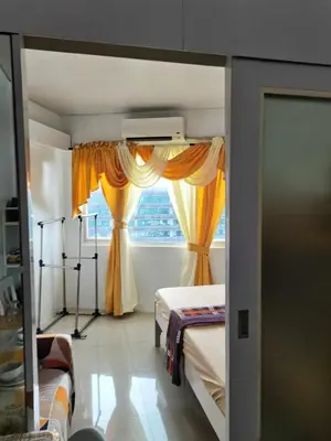 a bedroom with two beds and a window at Shell Condotel MOA Pasay in Manila