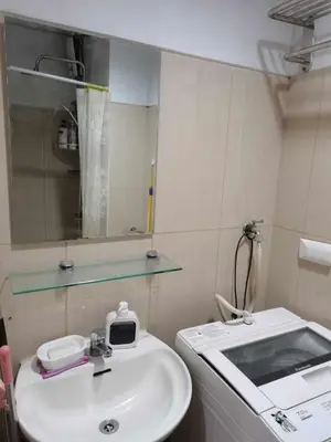 a bathroom with a sink and a mirror at Shell Condotel MOA Pasay in Manila