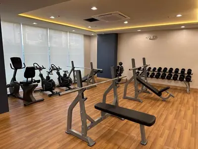 a gym with several treadmills and exercise bikes at Tulip Garden condo in Biñan