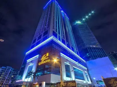 a tall building with blue lights on it at night at Spacious Cozy Corner in Manila