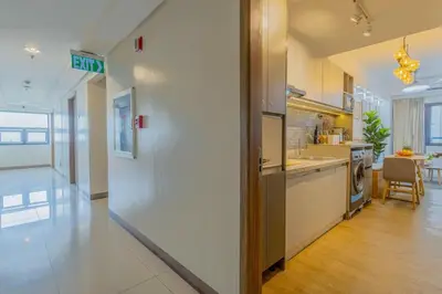 a large kitchen with a counter and a sink at Stylish Luxe 1 Bedroom Suite Near NAIA - FREE HIGH SPEED WIFI in Manila
