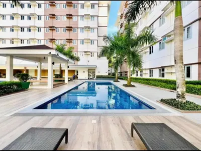a swimming pool in front of a building at The Tropical Suite SMDC Hope Residence in Trece Martires
