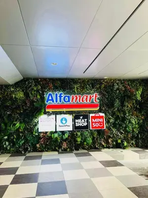 a wall of signs in a mall with a green wall at Atmosphere You Secret Hideaway in Manila