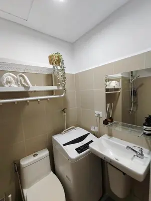 a bathroom with a toilet and a sink at Atmosphere You Secret Hideaway in Manila