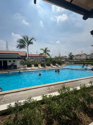 a large swimming pool with people swimming in it at Casa Mira in Dasmariñas