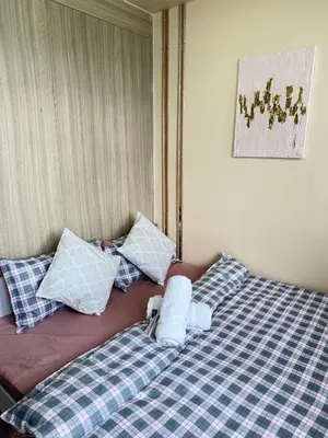 two beds sitting next to each other in a room at Manila Shore Residences Tower D MOA in Manila