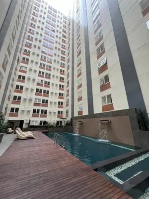 a swimming pool in front of two tall buildings at Ananda Square in Manila