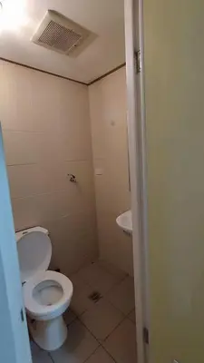 a bathroom with a toilet and a sink at Yuanhang 910 in Manila