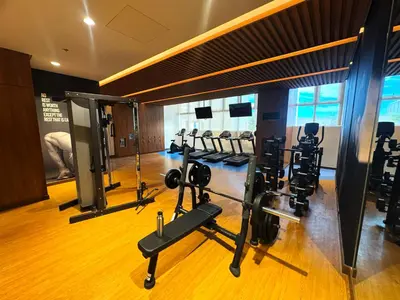 a gym with several treadmills and machines in it at Elegant 1 bedroom apartment with great facilities and perfect location in Manila