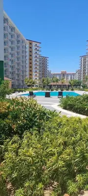 a view of a resort with a pool and buildings at King Elite Condo Hotel Field Residences Near NAIA Airport in Manila