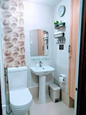 a bathroom with a white toilet and a sink at The Solace Place- Near Nuvali Sta Rosa Laguna in Bayabasan