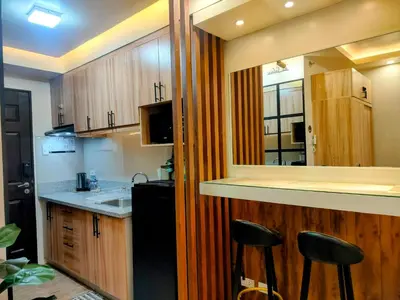 a kitchen with a sink and a counter with stools at The Solace Place- Near Nuvali Sta Rosa Laguna in Bayabasan