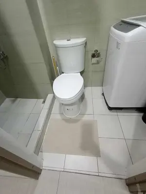 a bathroom with a toilet and a bath tub at Cozy Home near Mall of Asia with WIFI and Netflix in Manila