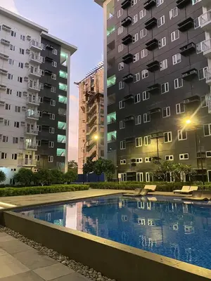 a swimming pool in front of two tall buildings at R and A Enclave in Manila