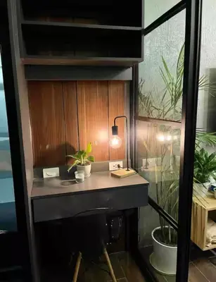 a desk in a room with potted plants on it at Luxurious 500MBPS 1BR in Makati in Manila