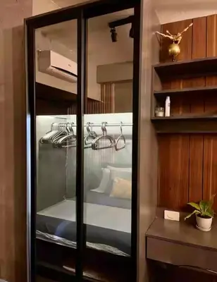 a glass cabinet in a room with a bed at Luxurious 500MBPS 1BR in Makati in Manila