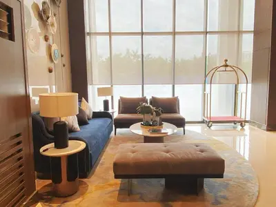 a living room with a blue couch and a table at 1BR 2 mins to Okada near MOA & Airport-12C in Manila