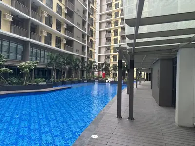 a large swimming pool in the middle of a building at 1BR 2 mins to Okada near MOA & Airport-12C in Manila