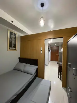 a bedroom with a bed and a dining room at Great Price and Location in Moa, Pasay City, Philippines in Manila