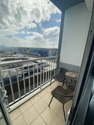 a balcony with chairs and a view of an airport at Great Price and Location in Moa, Pasay City, Philippines in Manila
