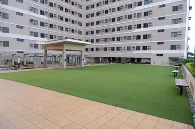 a large building with a green lawn in front of it at ARCHIVED 2019 - Cavite Condo with Resort-like Amenities & Hi Speed Wifi in Dasmariñas
