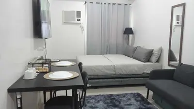 a small living room with a bed and a table at ARCHIVED 2019 - Cavite Condo with Resort-like Amenities & Hi Speed Wifi in Dasmariñas