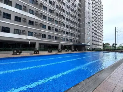 a swimming pool in front of a building at 2019 Cavite Green 2 Condo Amenities HI Speed Wifi in Dasmariñas