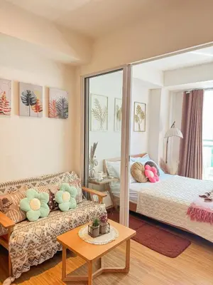 a living room with a bed and a couch at Maldives Tower Azure in Manila