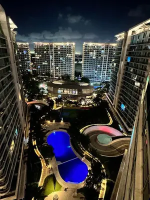 an aerial view of a city at night at The Bahamas & Maldives Suites by Azure Urban Resort Residences in Manila