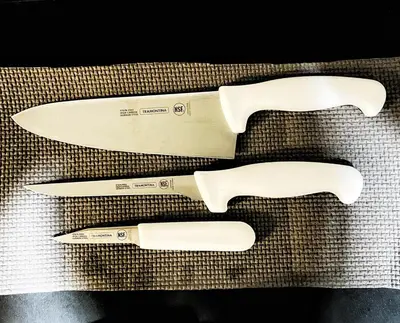 a group of three knives sitting on a table at Manila Bay, Seaside living near MOA, Studio unit in Manila