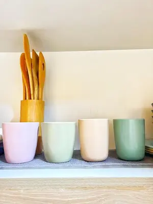 a row of bowls and utensils on a shelf at Manila Bay, Seaside living near MOA, Studio unit in Manila