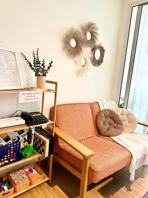 a living room with a couch with eyes on the wall at Cozy Stays - Azure in Manila