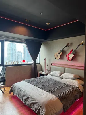 a bedroom with a bed and two guitars on the wall at Modern Nordic Noir Suite Cozy Luxury Scenic View in Manila