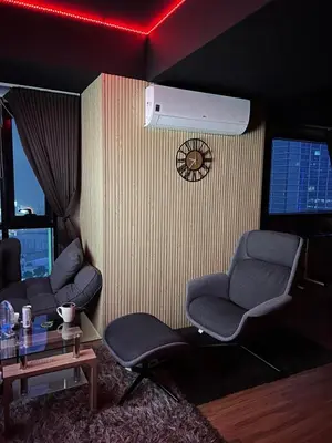 a living room with two chairs and a fan at Modern Nordic Noir Suite Cozy Luxury Scenic View in Manila