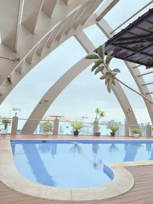 a swimming pool on the roof of a building at Cozy 2 BR 2 Bath Condo with Netflix and Karaoke near MRT EDSA in Manila