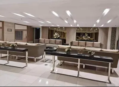 a lobby with couches and tables in a building at Field Residences Hotel Apartments Near Manila Airport in Manila