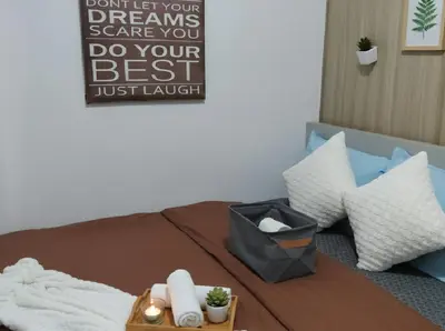 a bed with pillows and a sign that says dont let your dreams scare you at Mall of Asia - Pasay Condo in Manila