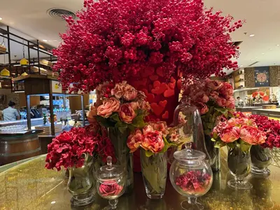 a group of vases filled with red flowers on a table at Large Family Groups in Air residence Makati Gym Swim Park 300 mbps in Manila
