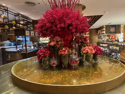 a bunch of flowers in vases on a table at Large Family Groups in Air residence Makati Gym Swim Park 300 mbps in Manila