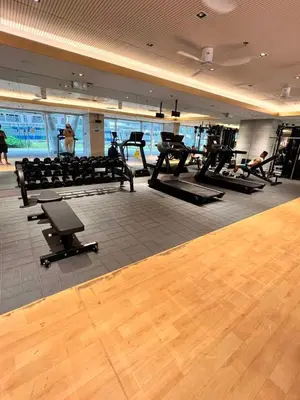a gym with a bunch of exercise equipment in it at Ortigas Greenfield Cozy Lodge in Manila