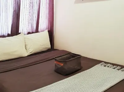 a small room with a bed with a bag on it at SMDC Ortigas FAME in Manila